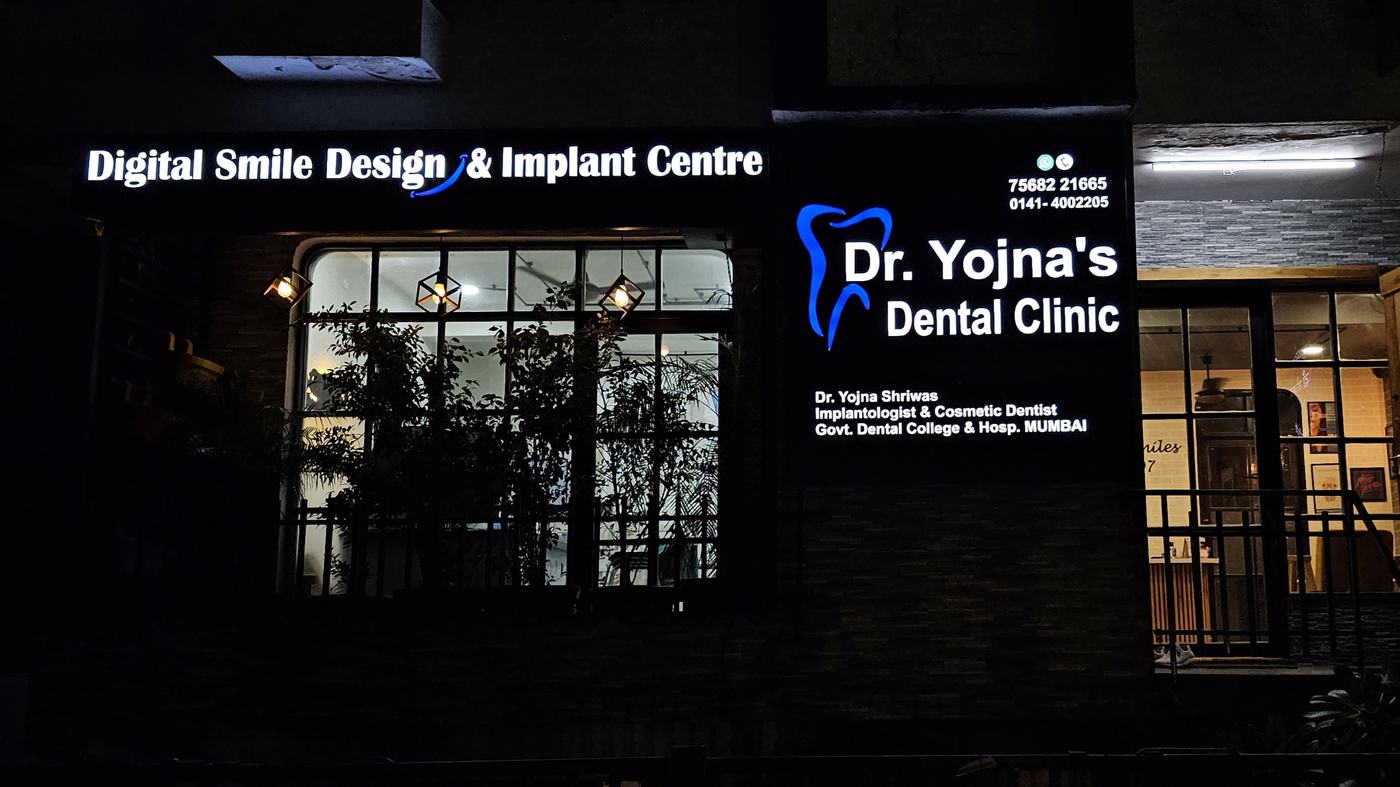 Clinic signage at night — Digital Smile Design and Implant Centre