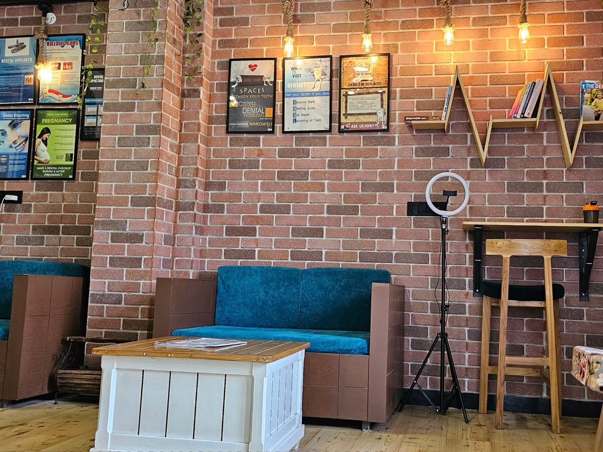 Waiting lounge with exposed brick and reading corner