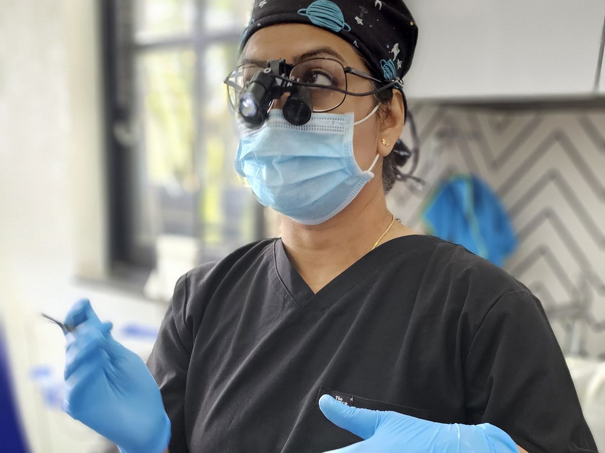 Dr. Yojna Shriwas with surgical loupes and headlamp during an implant procedure — Dr. Yojna's Dental Clinic, Jaipur