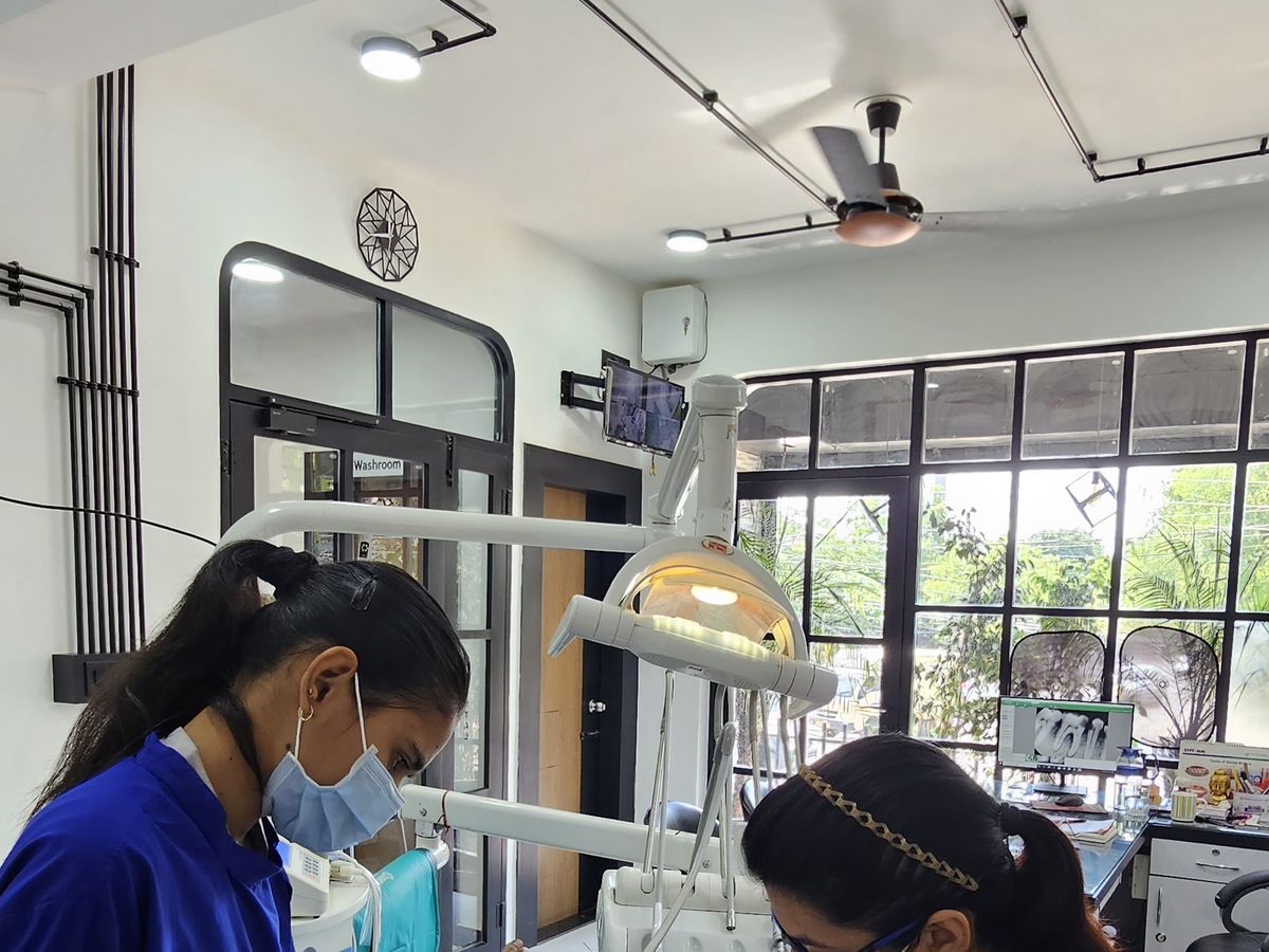 Root canal treatment in progress with four-handed assistance — Dr. Yojna's Dental Clinic, Jaipur